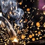 Industrial welder using professional welding equipment.